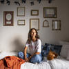 Student on bed in room
