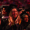 Temple students in graduate regalia celebrating at Commencement
