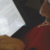 Student reading ipad