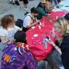 Students gathered around a table doing a craft