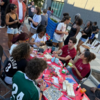 Group of people surrounding a table doing a craft